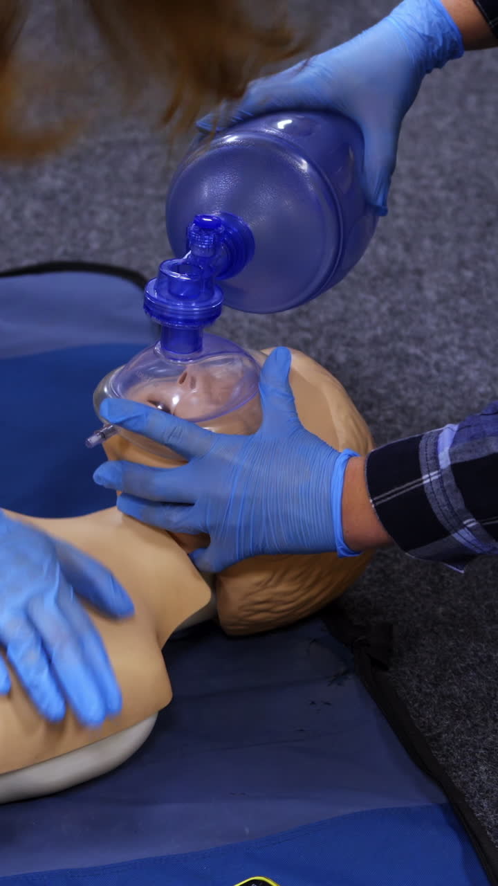 Medical dummy doll lays on blue blanket ready for training. First medical help with oxygen masks. First aid help. Vertical video