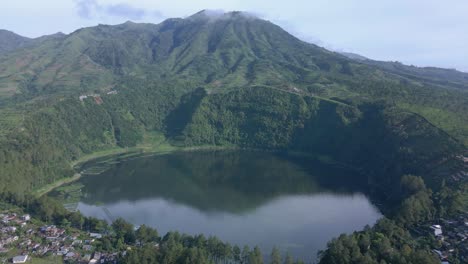 aerial view of crater lake on the mountain with forest vegetation