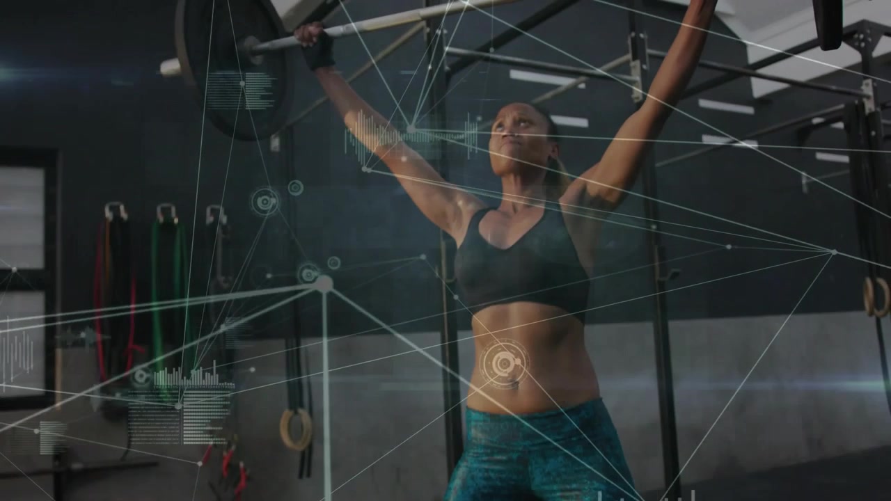 Lifting woman wearing sports bra pulling loaded barbell from squat to overhead lockout in gym, HUD
