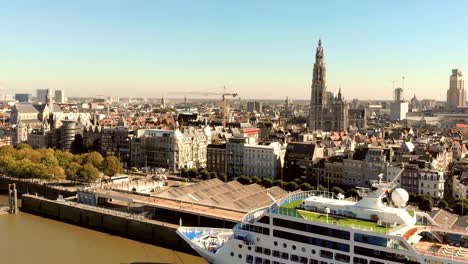 cathedral of our lady antwerp and antwerp cityscape. cruise ship docked at terminal.