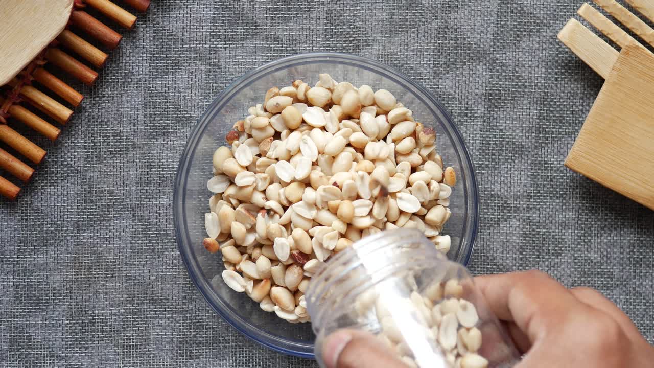 Pouring Peanuts into a Bowl