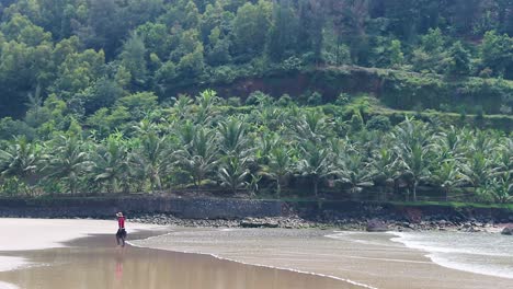 lonely person walking along the beach, slow motion shot, india beach side