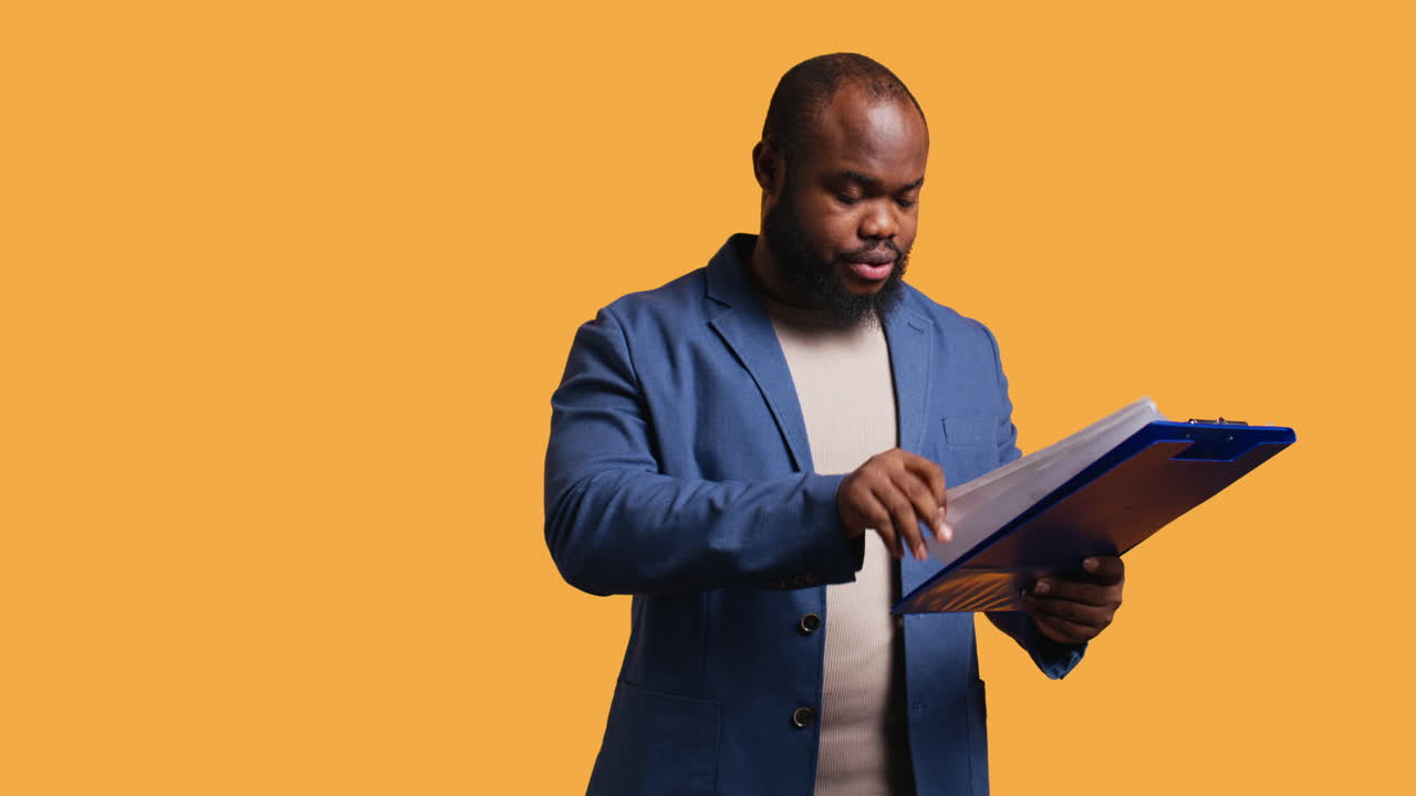 Man browsing though financial audit report on clipboard, pleased by high income