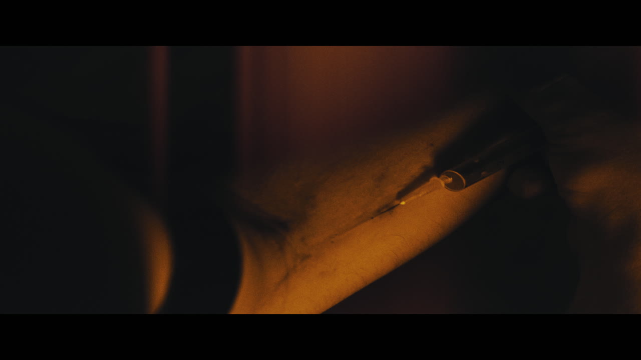 A syringe in the drug addict arm