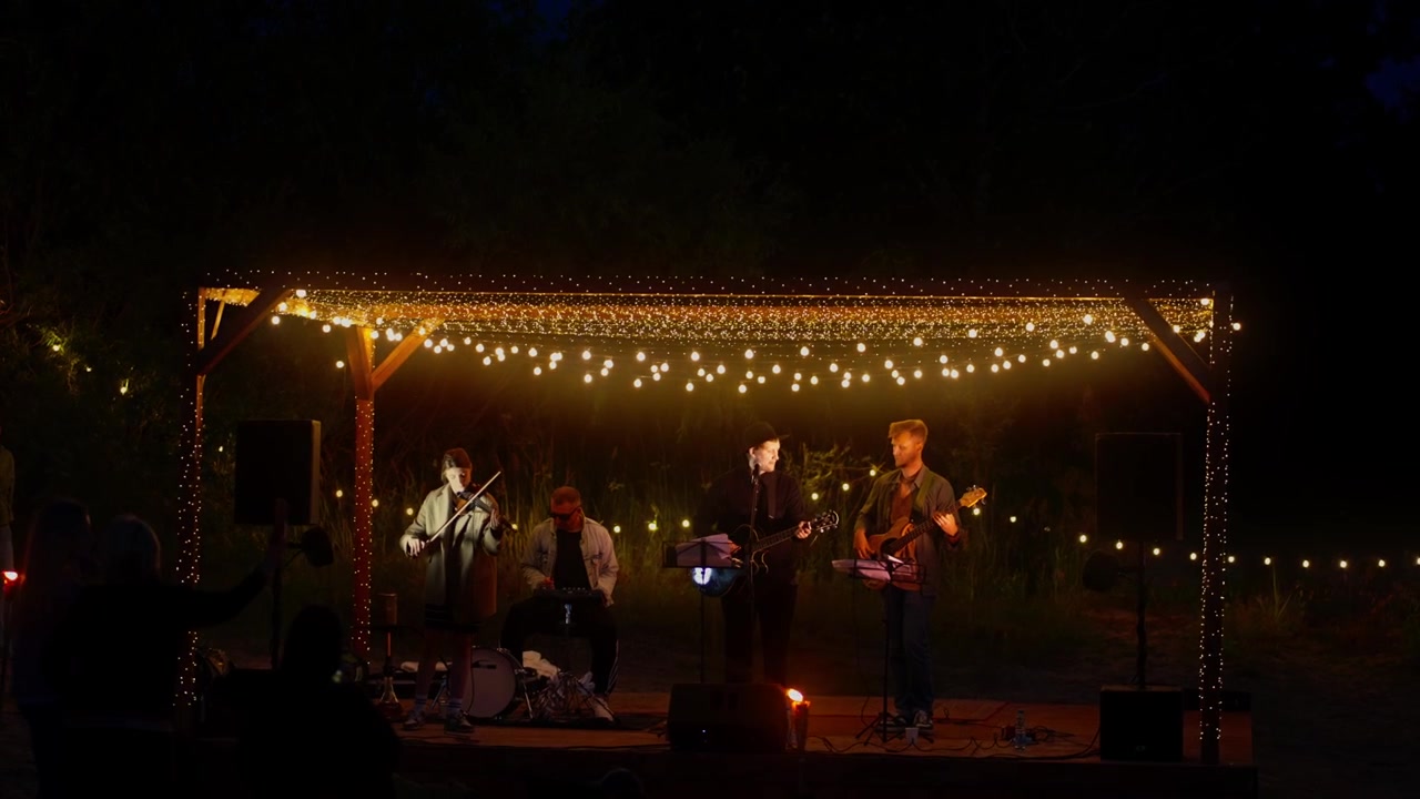 Musical Band Performing Live on Outdoor Stage at Night