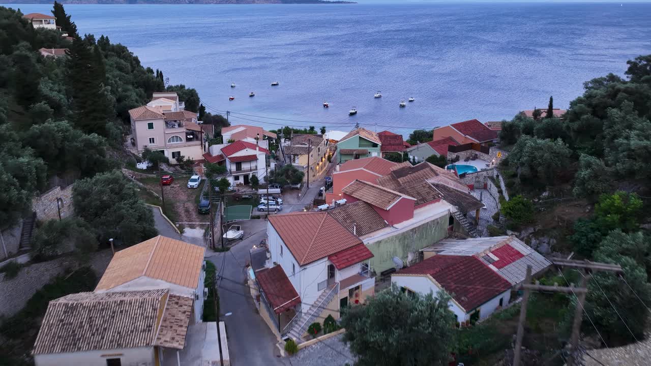 Kaminaki's Golden Hour: Warm Lights Illuminating a Traditional Corfu Beachfront Settlement