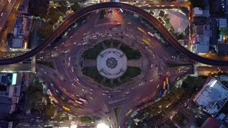 aerial view of huge roundabout and traffic lights at victory monument at night in bangkok, thailand