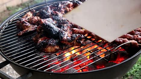 cooking meat on a charcoal barbecue