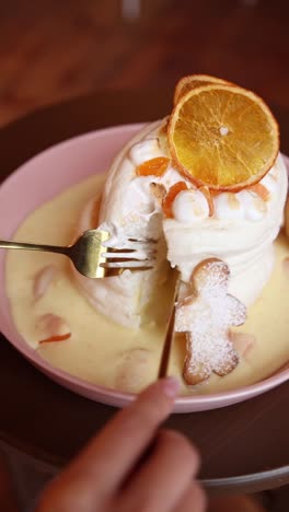 layered meringue dessert with orange slices and gingerbread cookies