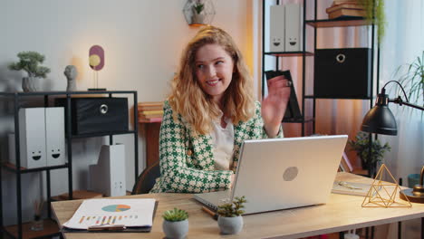 Businesswoman-employee-waves-hand-hi-gesture-greeting-welcomes-someone-at-camera-online-webinar