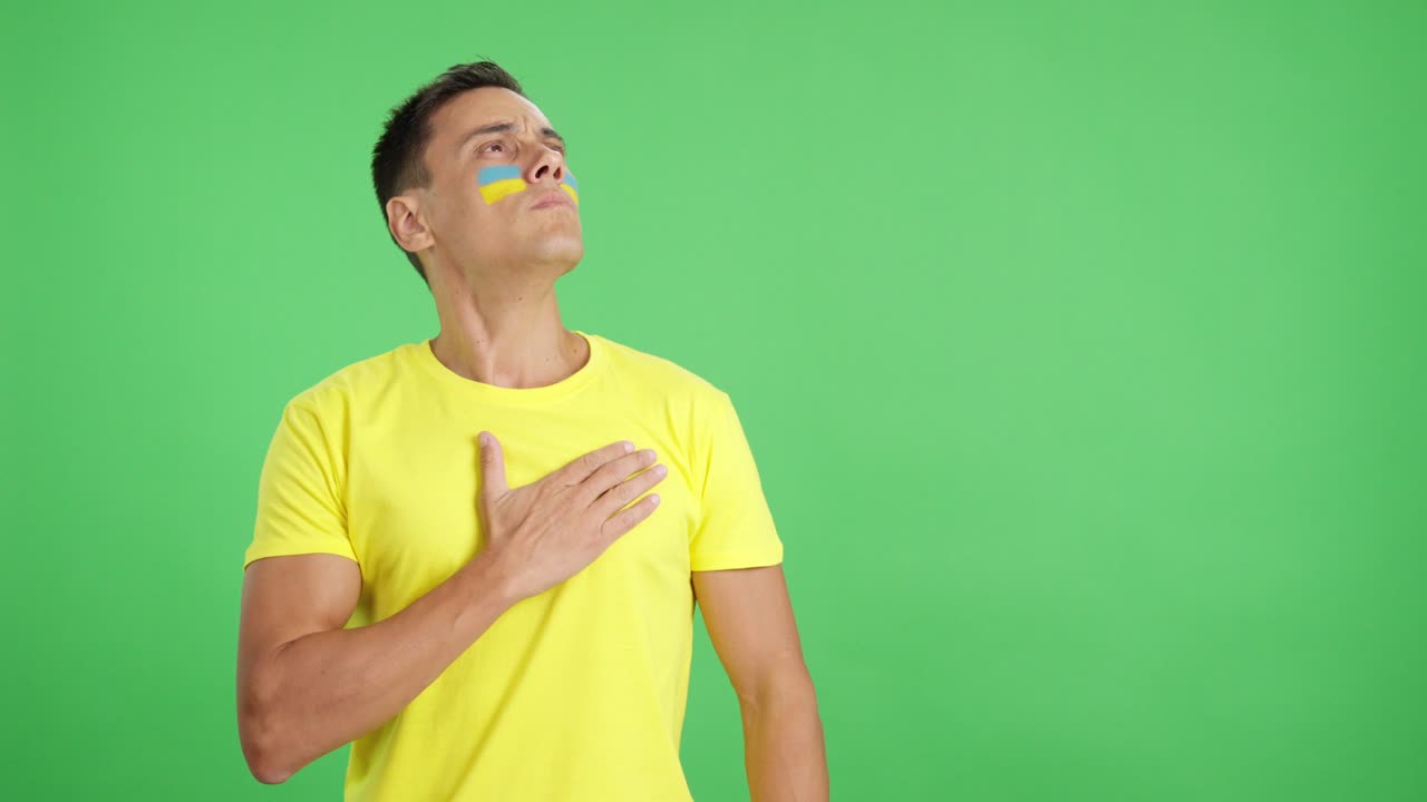 Ukrainian patriot listening to the national anthem with solemnity