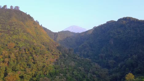 Fly-over-Steep-cliff-between-2-hills-overgrown-with-dense-forest