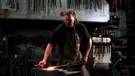 blacksmith working on a iron rod