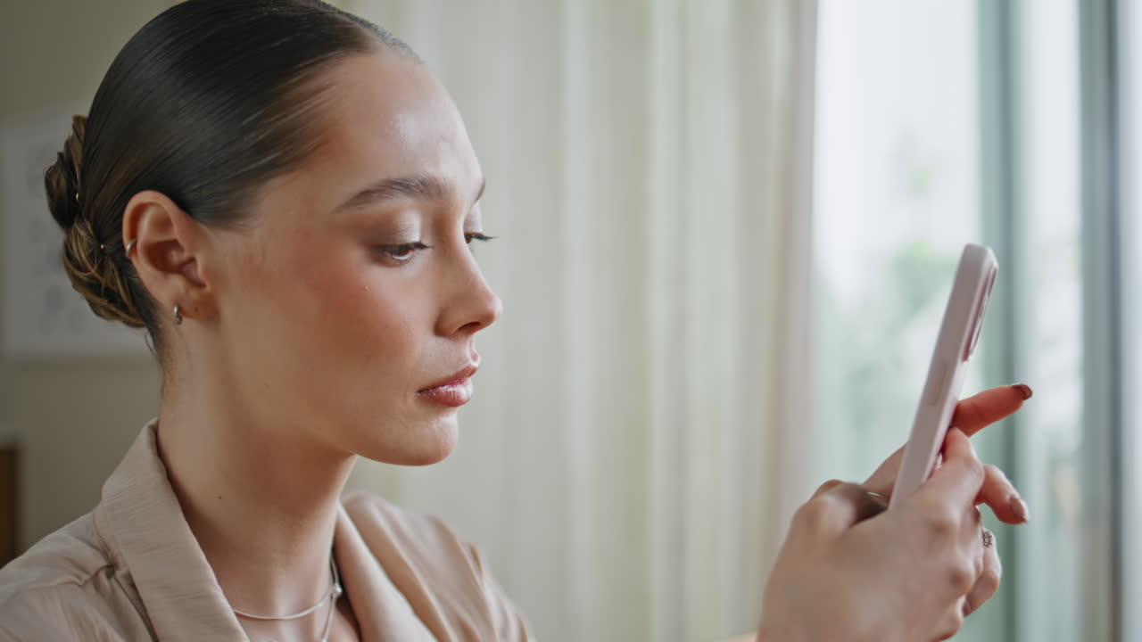Serious lady browsing smartphone app at apartment closeup. Elegant woman phone