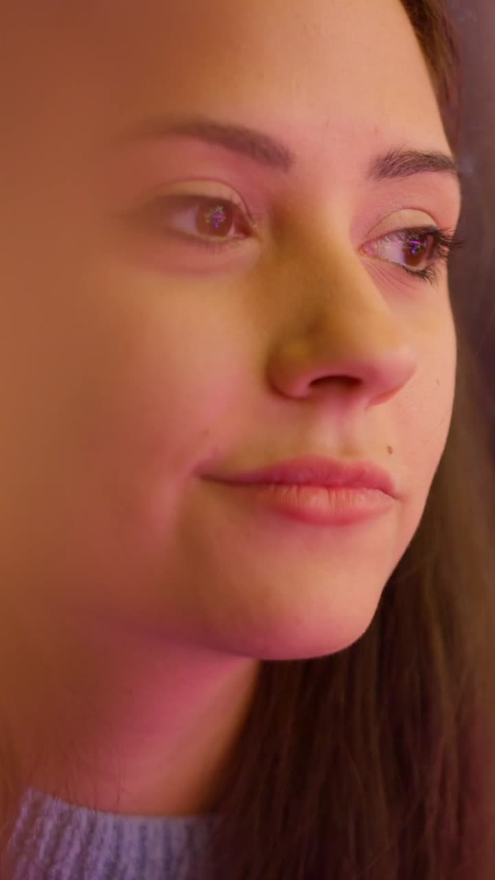 Woman's Face with Digital Reflections and Colorful Lighting