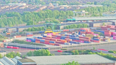 aerial view of stacked shipping containers in the distance, shipping port in industrial area, manchester uk