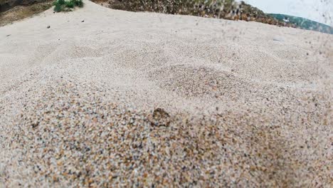 sand grains falling in ultra slow motion on beach