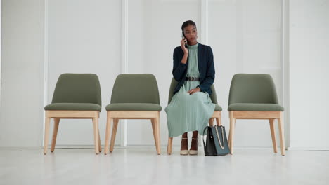 a woman in a waiting room on a phone call