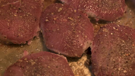 beef steaks of delicious juicy meat steaks cooking in frying pan