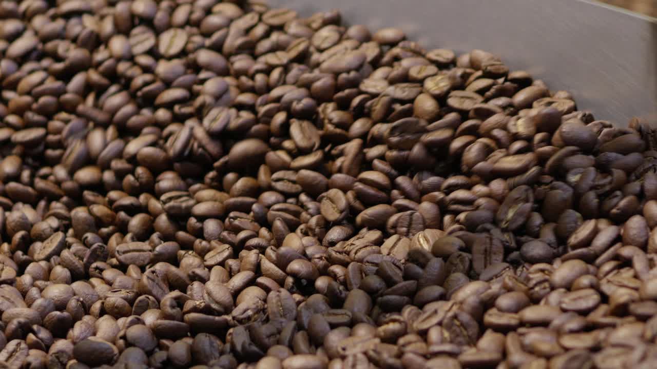 Discover the intricate journey of coffee beans from roasting to brewing in a rustic roastery.