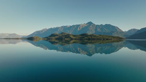 soaring low above water surface towards pigeon island in lake wakatipu