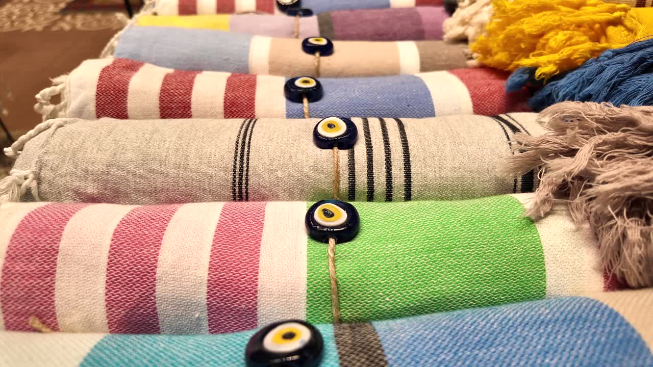 Colorful Striped Turkish Towels with Evil Eye Decorations