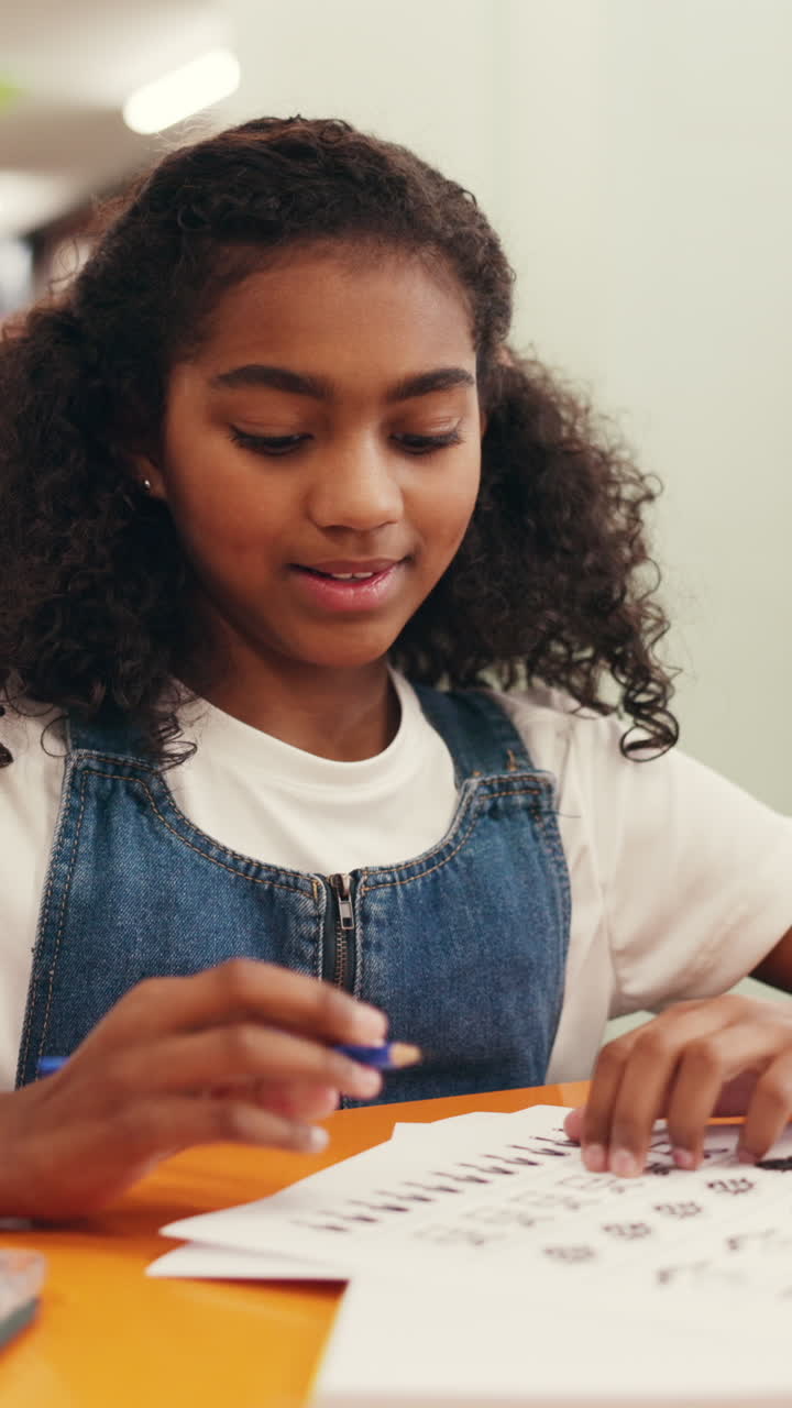 Happy Young Girl Writing and Learning at a Desk