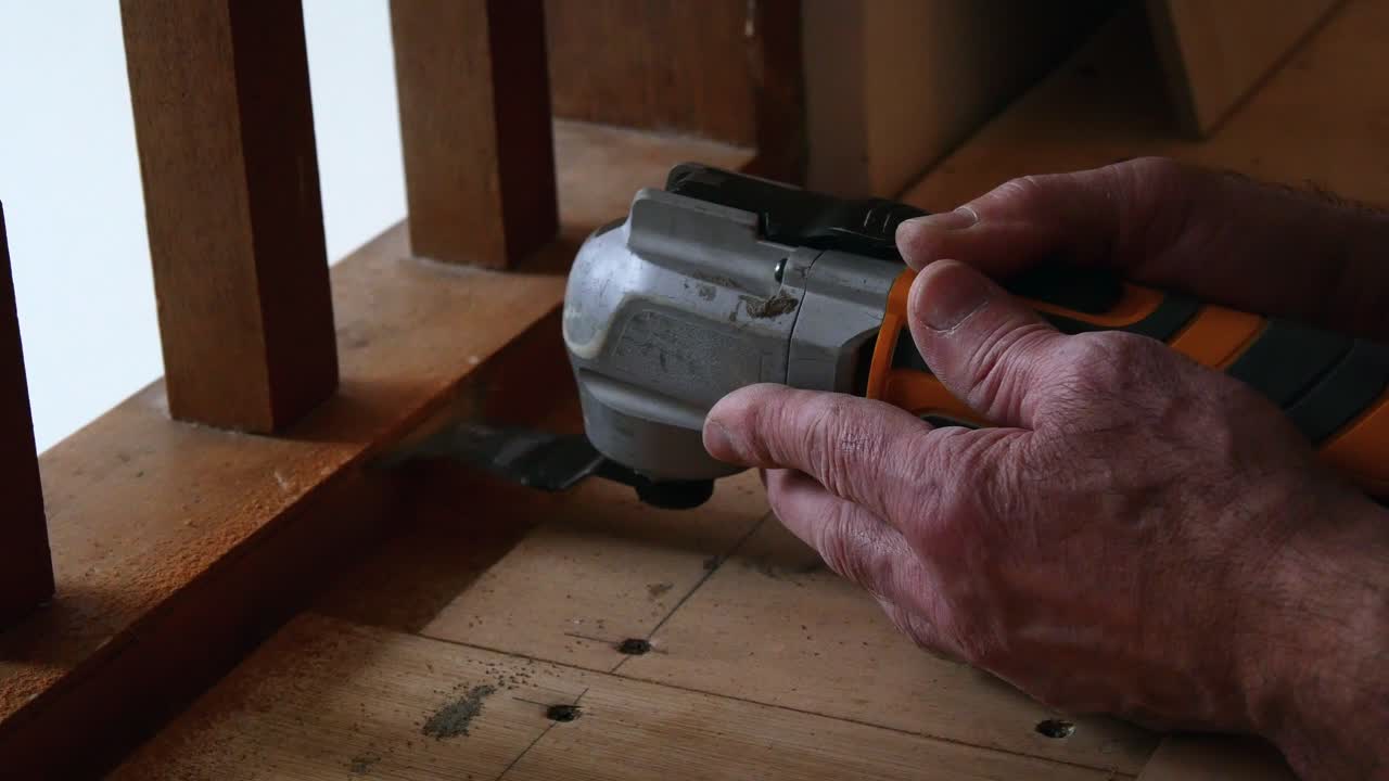 Workman sanding wooden banister, close up