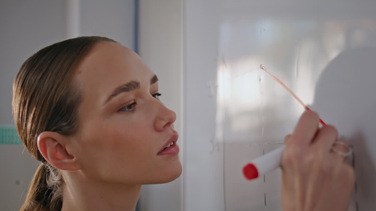 Focused educator writing board solving equation closeup. Woman teaching math