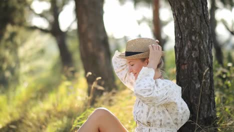 beautiful young woman sitting on a bench in the countryside taking a break resting and contemplati beautiful young woman sitting on a bench in the countryside taking a break resting and contemplating the surroundings on a cold and windy winter day