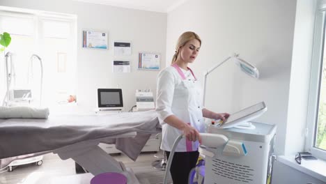 cosmetologist smoothes wrinkles with microcurrent. hardware procedure in cosmetology. peeling, phonophoresis, massage and facelift in a beauty clinic.