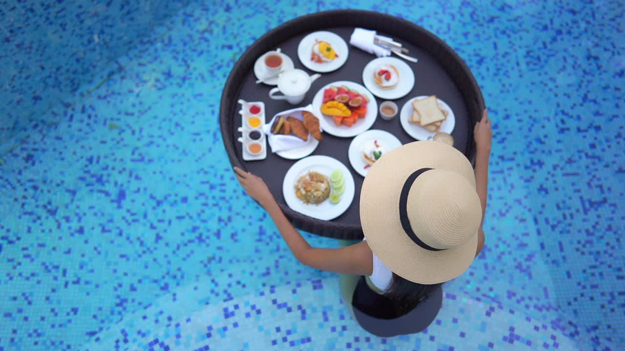 Breakfast in Pool. Overlook of Stylish Female With Big Floating Meal Plate. Luxury Vacation Concept