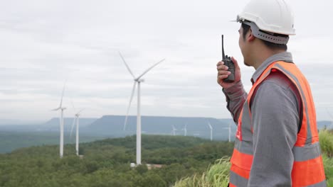 Progressive-concept-of-engineer-working-in-the-wind-farm-atop-of-the-mountain.