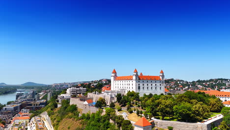 Rising along the hill where Bratislava Castle stands. View on the Slovakia landmark at the backdrop of blue clear sky