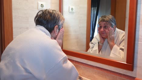 Woman-washing-face-in-bathroom