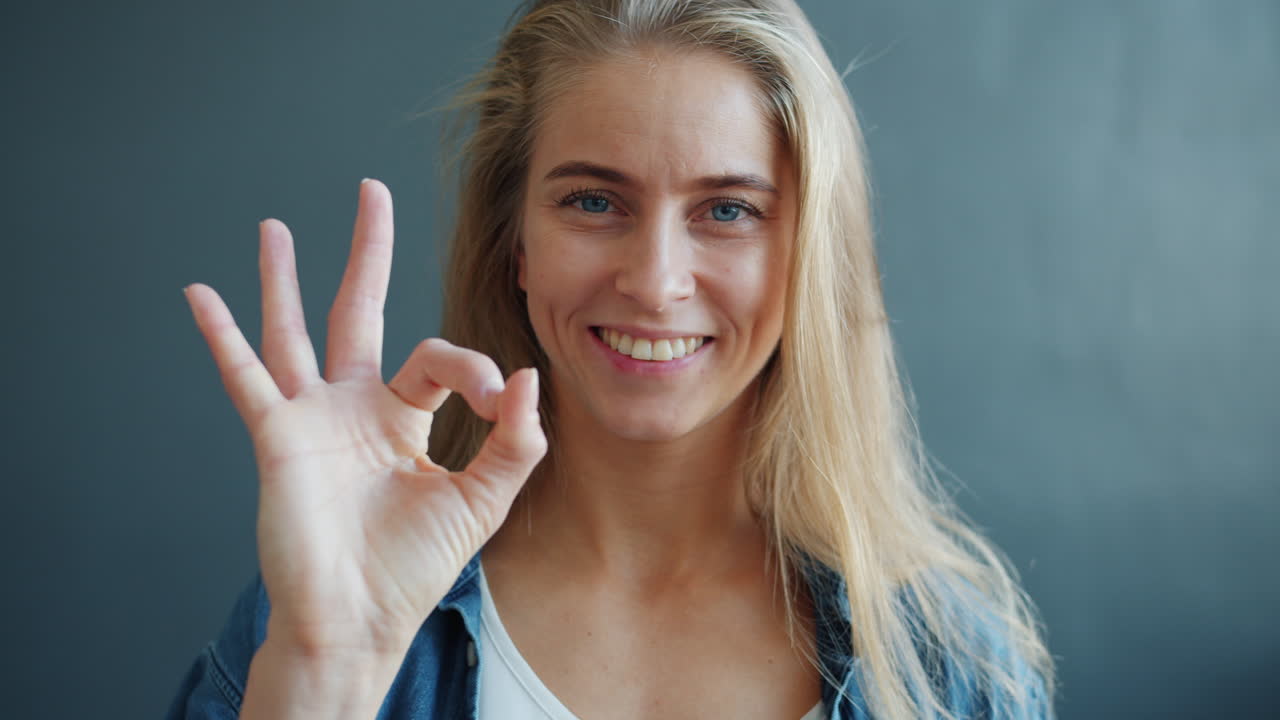 Woman Smiling and Showing the Ok Hand Gesture