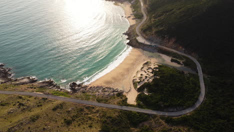 Exotic-sandy-beach-of-Vietnam-with-coastal-road,-aerial-view