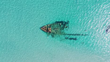 Old-shipwreck-in-turquoise-sea-water-from-above