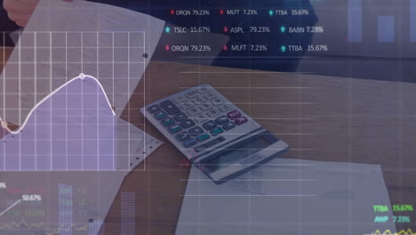 animation of financial data over documents and calculator lying on desk