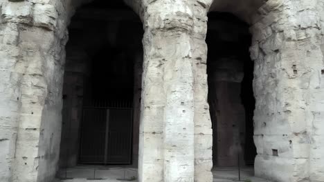 the moving view on the massive arches of the world-known colosseum. the fascinating four-storey amphitheater built during the roman empire