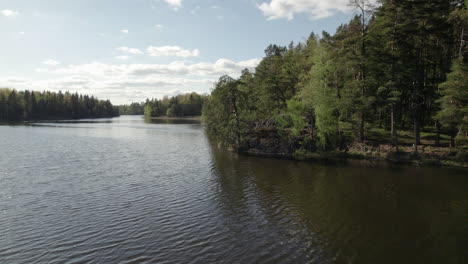 Niedrige-Luftaufnahme-über-Einem-Wunderschönen-See,-Umgeben-Von-Bäumen-In-Schweden