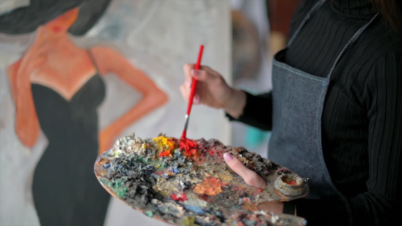 Woman painting a female on a canvas at an art gallery workshop