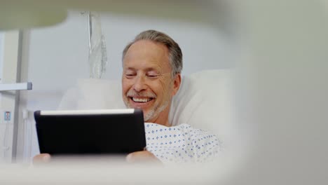 Patient-using-digital-tablet-on-bed