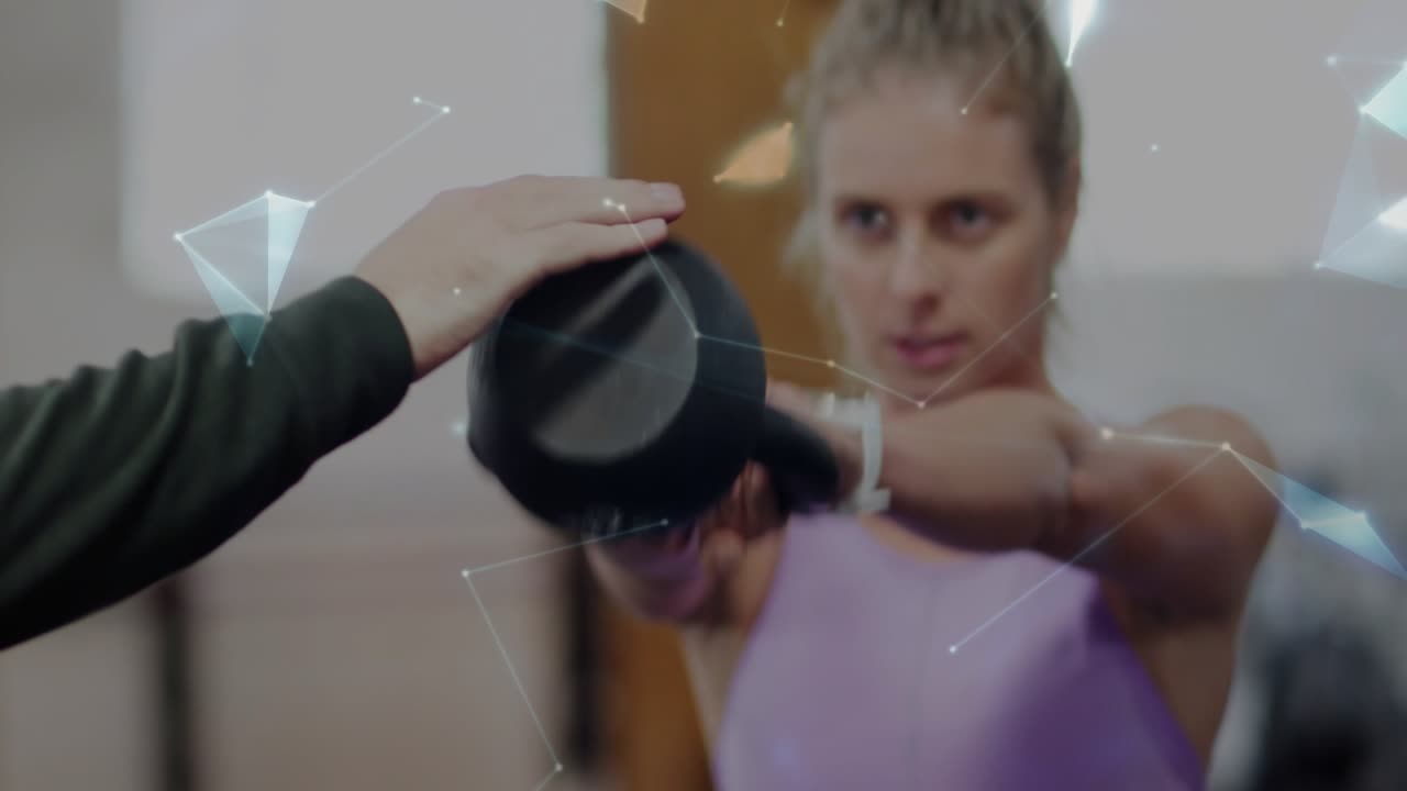 Fitness trainee starting kettlebell swing for form coach guiding while AR network morphing to globe