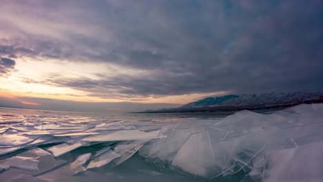 A-city-across-a-frozen-lake-with-rafted-ice-in-the-foreground---sunrise-time-lapse