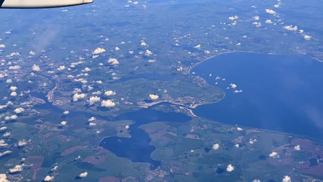 tilt up footage of jet airbus a320 airplane wing flying up in blue sky