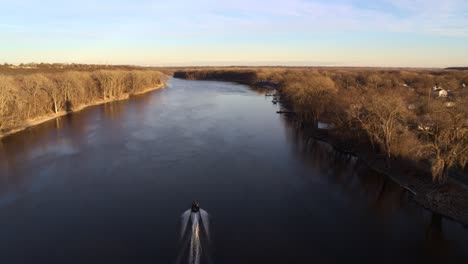 seen from above, a boat passes under the old hastings rail bridge in minnesota