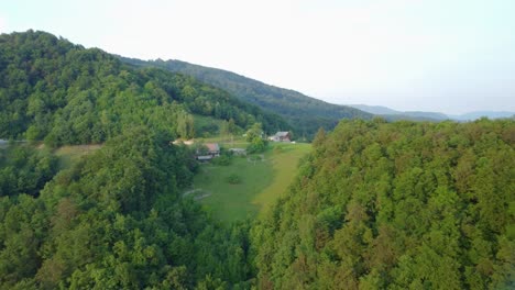 Old-vintage-farm-houses-high-in-hills-between-green-forests-and-meadows