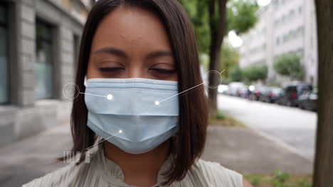 Female-model-wears-hygienic-respirator-in-the-street,-which-is-analyzed-with-a-digital-overlay