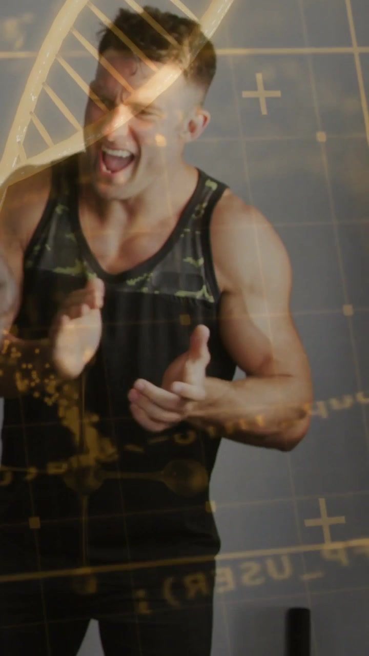 Man receiving offscreen cue, smiling into laughter and clapping while gold bio DNA helix over chest